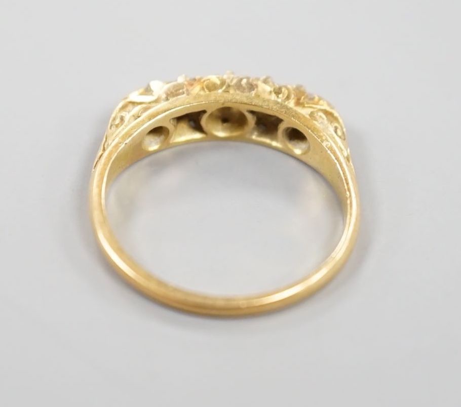 An 18ct and graduated five stone diamond set half hoop ring, size I, gross 2.8 grams.